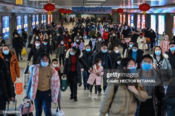 Passengers arrive to Hankou railway station in Wuhan, in Hubei province, on January 20 as people travel to their hometowns for Lunar New Year...