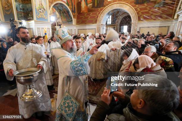 Primate of the Orthodox Church of Ukraine, Metropolitan Epifanii of Kyiv and All Ukraine blesses devotees with holy water the Divine Liturgy at...