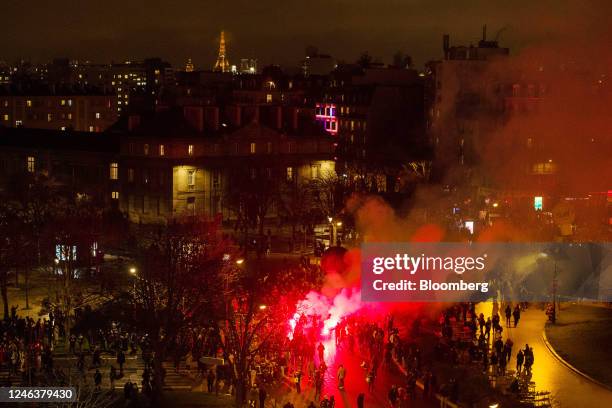 Demonstrators let off a flare at a protest, during a national strike against government plans to revamp the pension system, at Place de la Nation in...