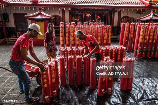 Temple staff assemble giant candles sent by Confucians at the Dhanagun monastery, in Bogor, on January 20 two days before the Chinese New Year...