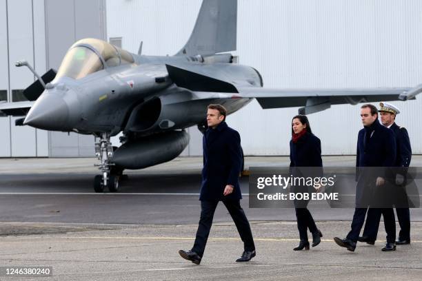 French President Emmanuel Macron, followed by French Armies Minister Sebastien Lecornu , walks past a Dassault Rafale fighter aircraft during his New...