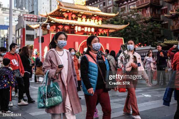 People visit a traditional Spring Festival flower market which reopens after closure due to the spread of the Covid-19 coronavirus in Guangzhou, in...