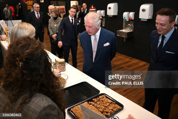 Britain's King Charles III visits the kitchen inside the headquarters of cereal manufacturer Kellogg's marking its 100th anniversary in Manchester,...