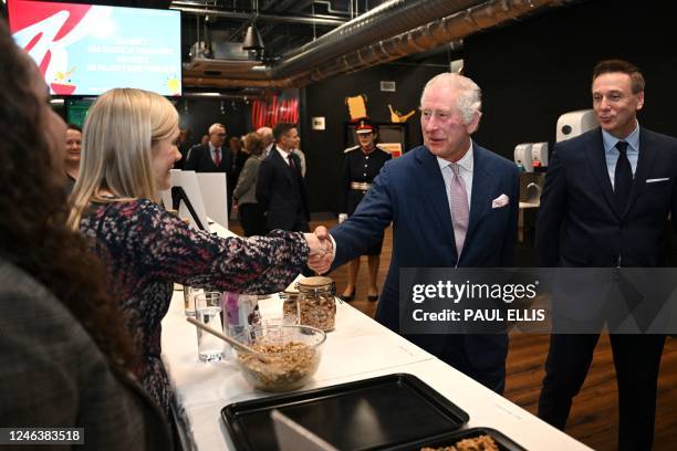 Britain's King Charles III visits the kitchen inside the headquarters of cereal manufacturer Kellogg's marking its 100th anniversary in Manchester,...