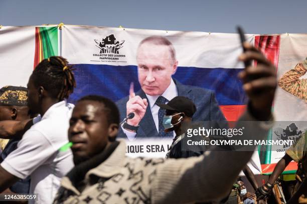 Banner of Russian President Vladimir Putin is seen during a protest to support the Burkina Faso President Captain Ibrahim Traore and to demand the...