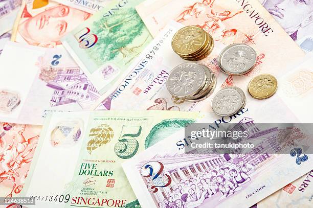 singapore banknotes and coins - singapore currency stock pictures, royalty-free photos & images