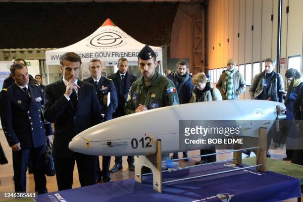 French President Emmanuel Macron watches a military drone as he visits the Mont-de-Marsan air base, southwestern France, to deliver his New Year...