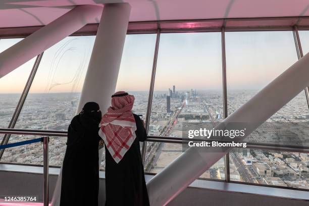 Visitors looks out towards the city skyline from the skybridge of the Kingdom Center, in Riyadh, Saudi Arabia, on Thursday, Jan. 19, 2023. Mostly...