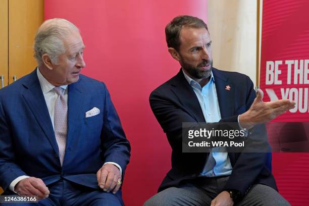 Britain's King Charles III talks to Gareth Southgate, England football manager and Prince's Trust ambassador during a visit to the Norbrook Community...