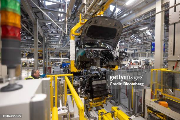 The chassis and engine of a Range Rover hybrid sports utility vehicle at Tata Motors Ltd.'s Jaguar Land Rover vehicle manufacturing plant in...