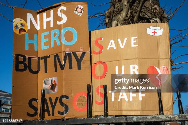 Signs are pictured at an official picket line for striking nurses outside St George's Hospital in Tooting on 19 January 2023 in London, United...