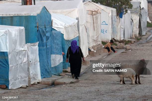 Displaced Iraqi woman from the Yazidi community walks in front of tents at a camp for internally displaced persons in Khanke, a few kilometres from...