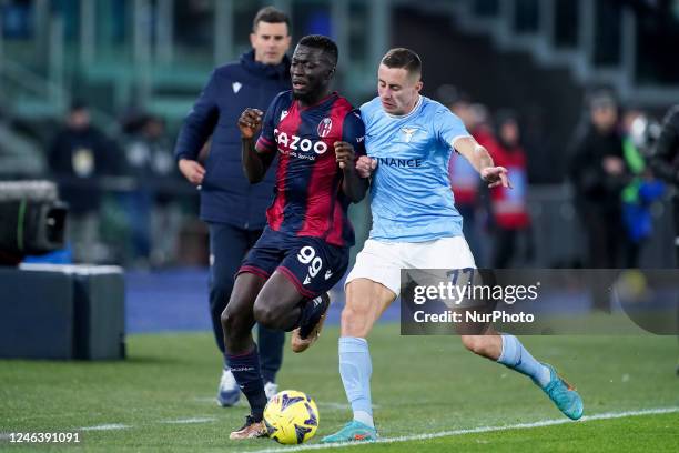 Musa Barrow of Bologna FC and Adam Marusic of SS Lazio compete for the ball during the Coppa Italia match between SS Lazio and Bologna FC at Stadio...