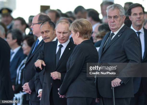 In this file photo German Chancellor Angela Merkel and Russian President Vladimir Putin came face to face as they attend commemoration ceremonies...