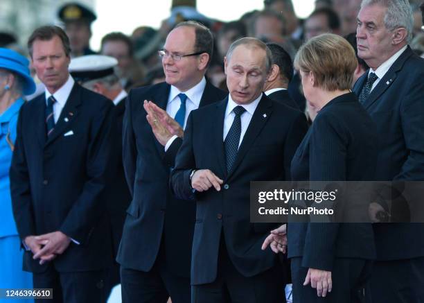 In this file photo German Chancellor Angela Merkel and Russian President Vladimir Putin came face to face as they attend commemoration ceremonies...