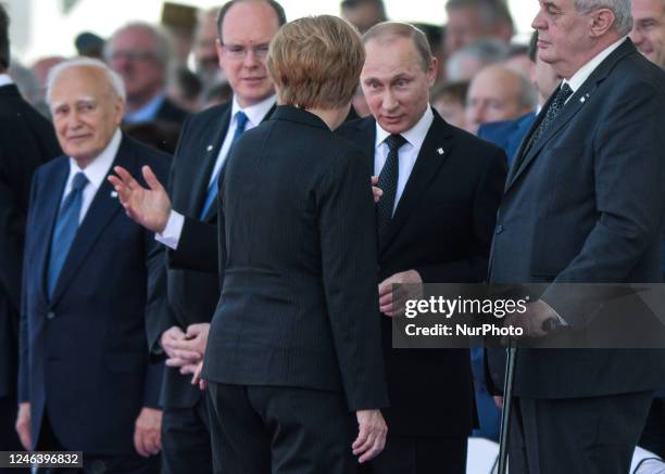 In this file photo German Chancellor Angela Merkel and Russian President Vladimir Putin came face to face as they attend commemoration ceremonies...