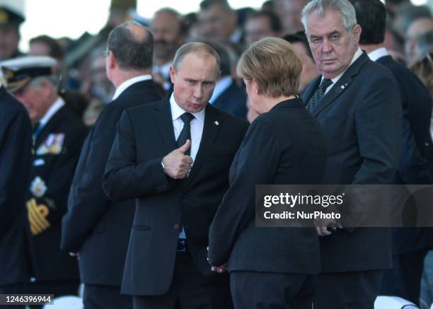 In this file photo German Chancellor Angela Merkel and Russian President Vladimir Putin came face to face as they attend commemoration ceremonies...