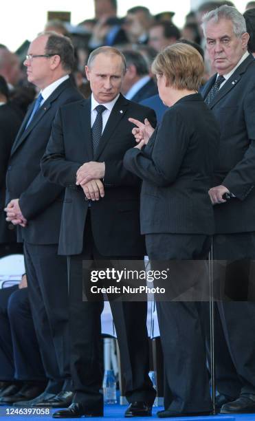 In this file photo German Chancellor Angela Merkel and Russian President Vladimir Putin came face to face as they attend commemoration ceremonies...