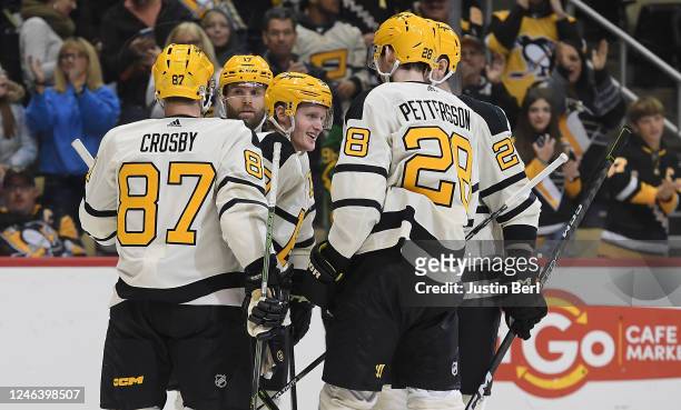 Jake Guentzel of the Pittsburgh Penguins celebrates with teammates after scoring a goal in the third period during the game against the Ottawa...