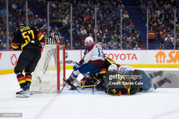 Tyler Myers, Quinn Hughes, Elias Pettersson and Collin Delia of the Vancouver Canucks defend against Valeri Nichushkin and Artturi Lehkonen of the...