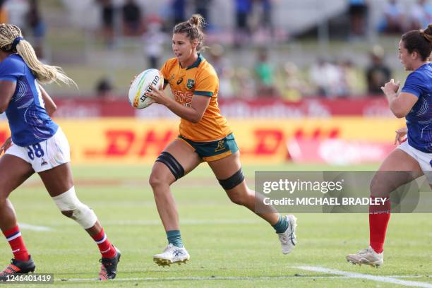 Demi Hayes of Australia runs the ball during the women's match between Australia and France on day one of the World Rugby Sevens series at FMG...