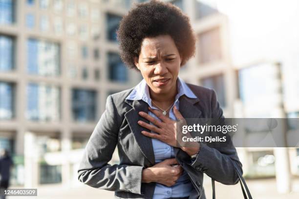 woman having chest pain. - heartburn stock pictures, royalty-free photos & images