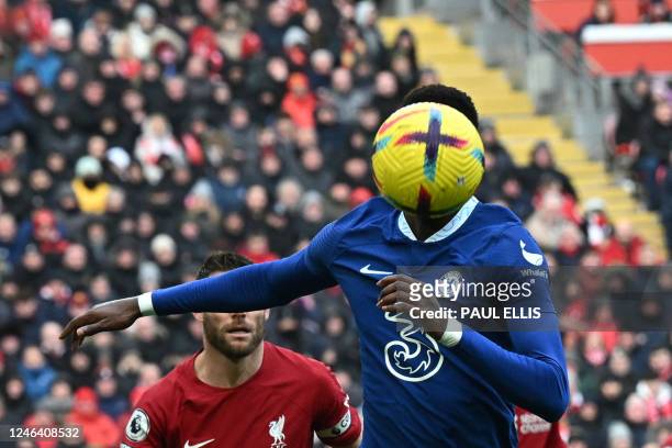Chelsea's French defender Benoit Badiashile eyes the ball during the English Premier League football match between Liverpool and Chelsea at Anfield...