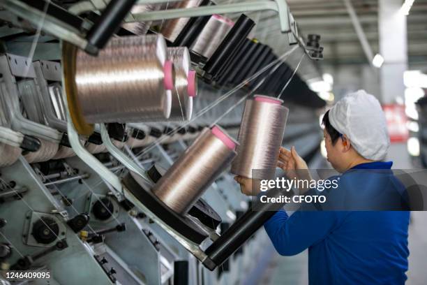 Textile workers work on the front line of production at Jiangsu Tongxin Chemical Fiber Co., LTD., Jan 21, 2023.