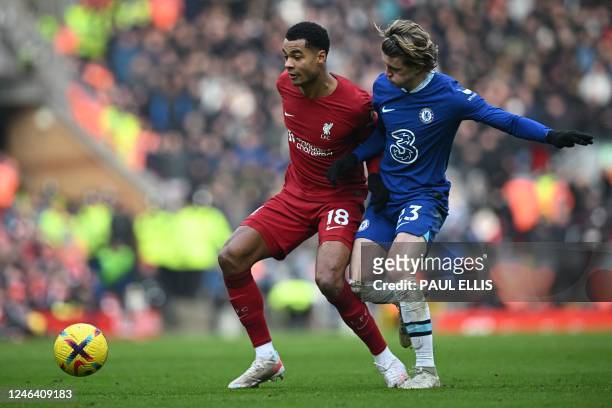 Liverpool's Dutch striker Cody Gakpo fights for the ball with Chelsea's English midfielder Conor Gallagher during the English Premier League football...