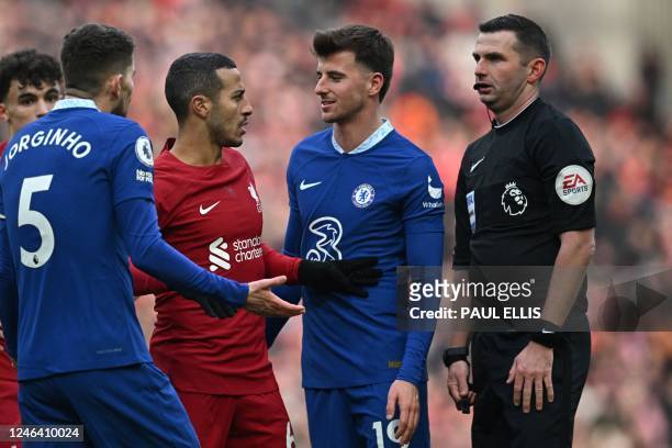 Liverpool's Spanish midfielder Thiago Alcantara argues with English referee Michael Oliver to ask for a handball during the English Premier League...