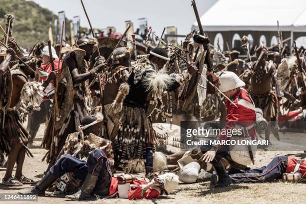 Amabutho Zulu regiments use a spear on a falling British soldier during the reenactment of the Battle of Isandlwana, in Isandlwana on January 21,...