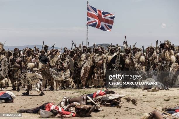 Amabutho Zulu regiments hold a British flag captured during the reenactment of the Battle of Isandlwana, in Isandlwana on January 21, 2023. - The...