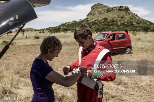 Member of the Dundee Diehards is helped with his uniform by his mother before the reenactment of the Battle of Isandlwana, in Isandlwana on January...
