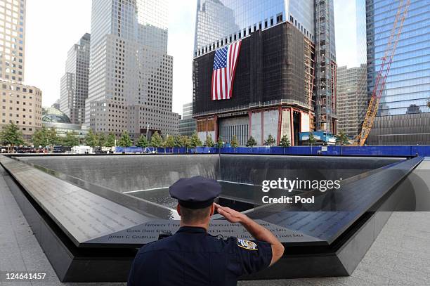 New York City Police Officer Danny Shea, a military vet, salutes at the North pool of the 9/11 Memorial during the tenth anniversary ceremonies of...