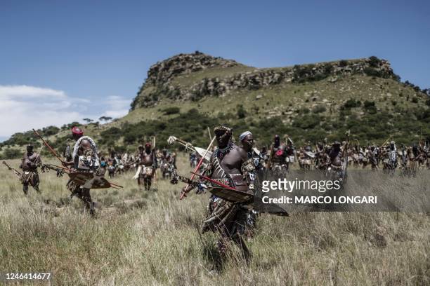 Amabutho Zulu regiments march towards the battlefield at the start of the reenactment of the Battle of Isandlwana, in Isandlwana on January 21, 2023....