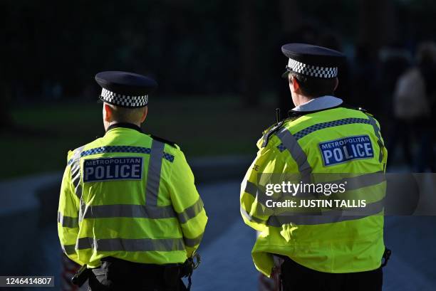 Metropolitan Police officers stand watching ahead of a protest march against the Islamic revolutionary Guard Corps , in central London, on January...