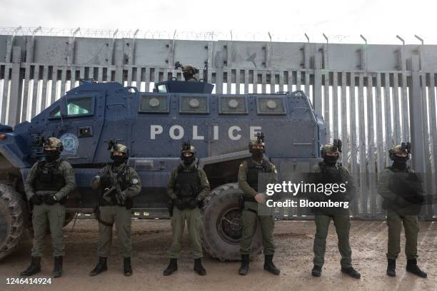 Greek border police with head mounted night-vision goggles stand by an armored vehicle at the border fence between Greece and Turkey, near Feres,...