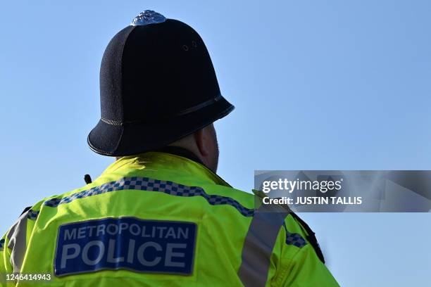 Metropolitan Police officer walks beside a protest march against the Islamic revolutionary Guard Corps , in central London, on January 21, 2023.