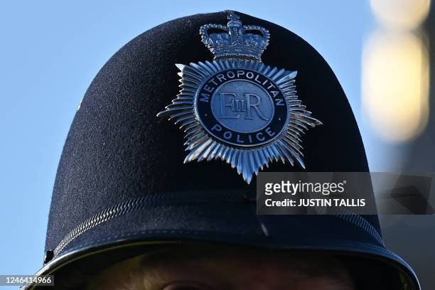 Metropolitan Police officers helmet is pictured as they walk beside a protest march against the Islamic revolutionary Guard Corps near Big Ben and...