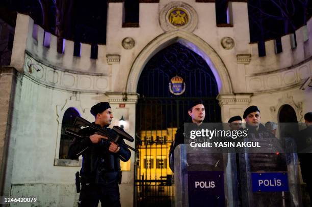 Riot police officers secure the entrance to the Consulate General of Sweden during a demonstration after Rasmus Paludan, leader of Danish far-right...