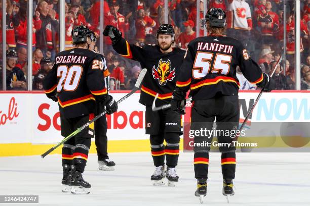 Rasmus Andersson, Blake Coleman and teammates of the Calgary Flames celebrate a goal against the Tampa Bay Lightning at Scotiabank Saddledome on...