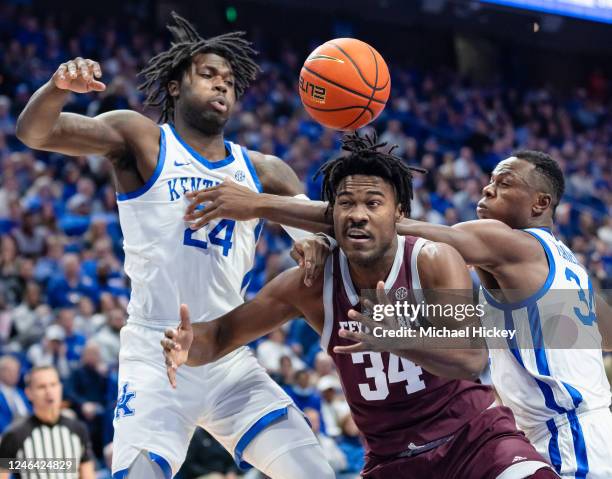 Julius Marble of the Texas A&M Aggies reaches for the rebound against Chris Livingston and Oscar Tshiebwe of the Kentucky Wildcats during the first...