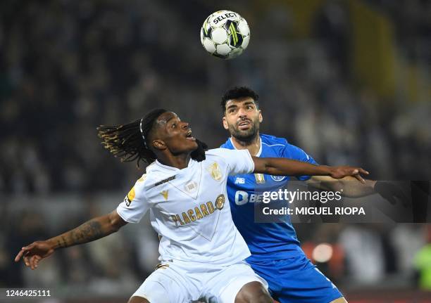 Vitoria Guimaraes' Italian midfielder Bamba vies with FC Porto's Iranian forward Mehdi Taremi during the Portuguese league football match between...