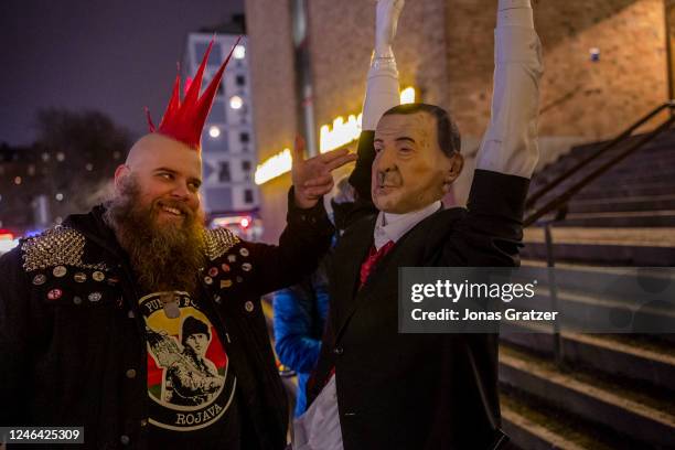 Protester shapes his fingers into a symbolic gun which he points at a doll representing the President of Turkey, Recep Tayyip Erdogan during a...