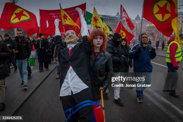 Protester pulls a cart in front of her with a Recep Tayyip Erdogan, doll during an Anti NATO and anti Turkey demonstration on January 21, 2023 in...