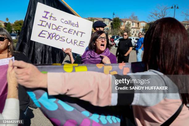 An anti-trans rights protester faces off against a pro-gender rights person during a demonstration against Christynne Wood, a transgender woman who...