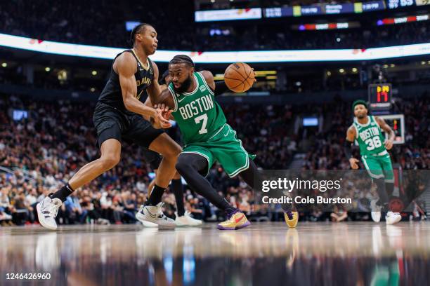 Jaylen Brown of the Boston Celtics goes to the net against Scottie Barnes of the Toronto Raptors during the first half of their NBA game at...