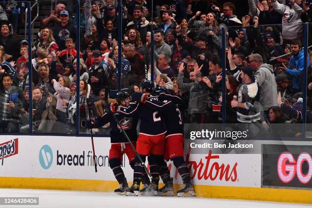 Boone Jenner of the Columbus Blue Jackets celebrates with teammates after scoring a goal during the second period of a game against the San Jose...