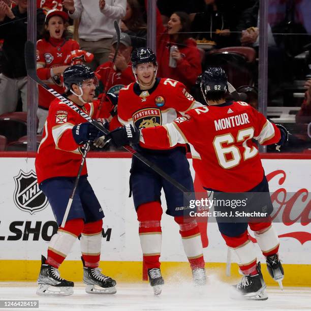 Eetu Luostarinen celebrates his goal with teammates Brandon Montour and Nick Cousins of the Florida Panthers during the second period against the...