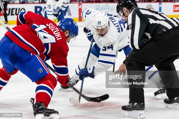 Nick Suzuki of the Montreal Canadiens faces off Auston Matthews of the Toronto Maple Leafs during the second period of the NHL regular season game...